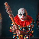 Mad bloody clown with baseball bat